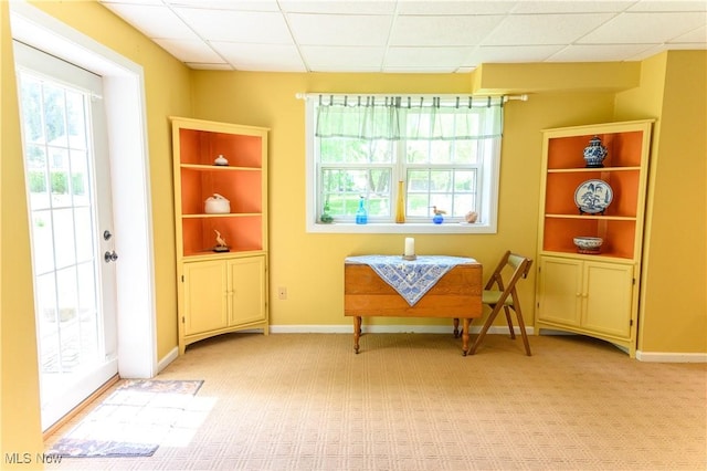sitting room featuring light colored carpet and baseboards