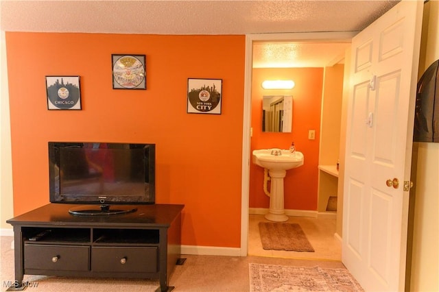 bathroom with a textured ceiling and baseboards