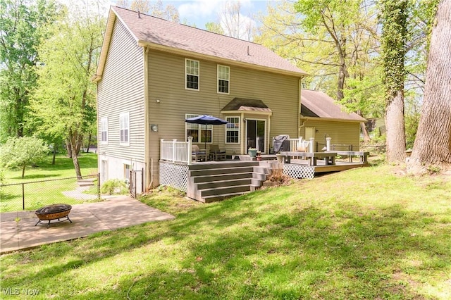 back of house featuring an outdoor fire pit, a patio, and a wooden deck