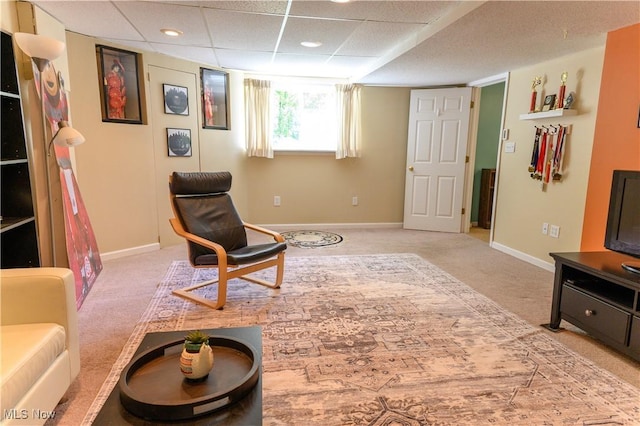 sitting room featuring light carpet and baseboards