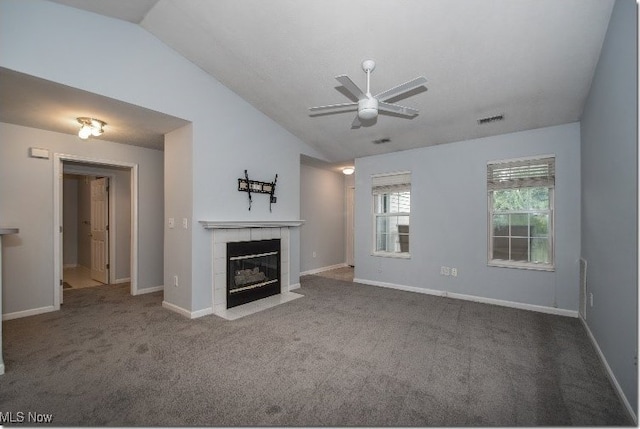 unfurnished living room featuring vaulted ceiling, a ceiling fan, carpet floors, a tile fireplace, and baseboards