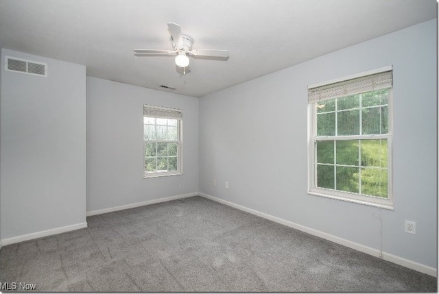 empty room featuring carpet flooring, ceiling fan, and baseboards