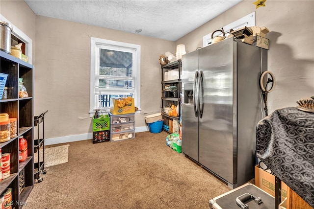 1821 E 30th St, Lorain, OH 44055 - kitchen with stainless steel fridge, carpet flooring, a textured ceiling, and baseboards