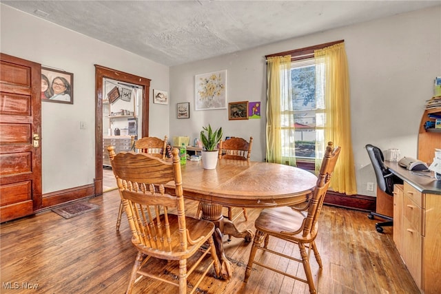 1821 E 30th St, Lorain, OH 44055 - dining area featuring light wood-style flooring, a textured ceiling, and an office area