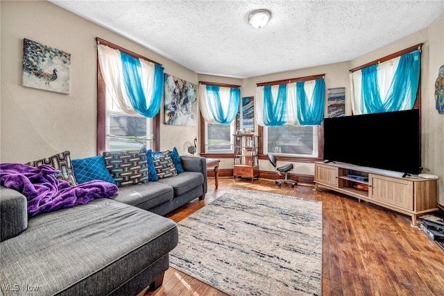 1821 E 30th St, Lorain, OH 44055 - living area with a textured ceiling and wood finished floors
