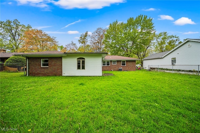 back of property featuring brick siding