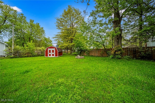 view of yard featuring a storage shed and an outbuilding