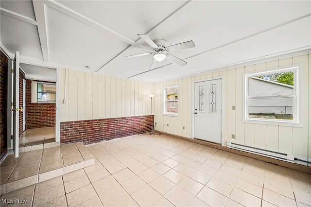 tiled spare room featuring brick wall and ceiling fan