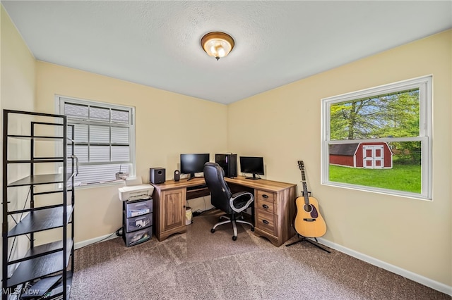 carpeted home office featuring baseboards