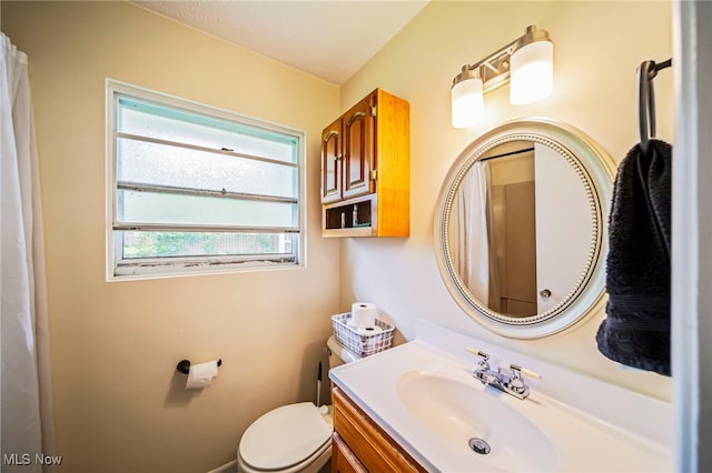 bathroom featuring vanity and toilet