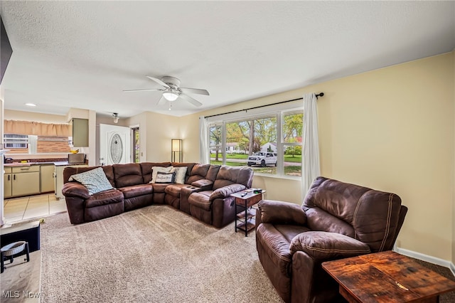 living room with ceiling fan and baseboards