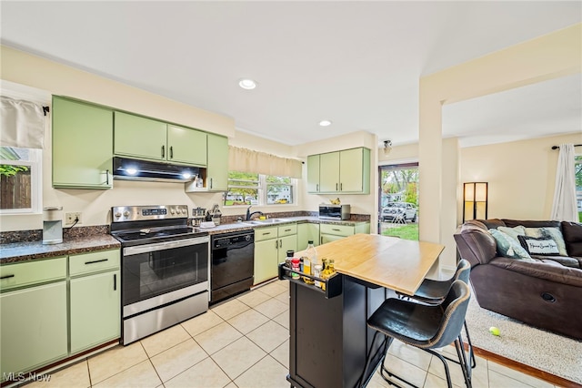 kitchen featuring appliances with stainless steel finishes, green cabinets, under cabinet range hood, a sink, and open floor plan