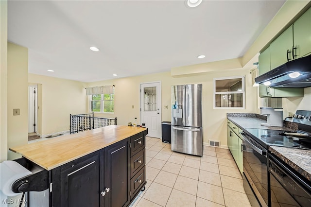 kitchen featuring stainless steel refrigerator with ice dispenser, black electric range oven, under cabinet range hood, wood counters, and light tile patterned floors