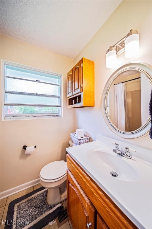 bathroom with tile patterned flooring, vanity, toilet, baseboards, and a shower with curtain