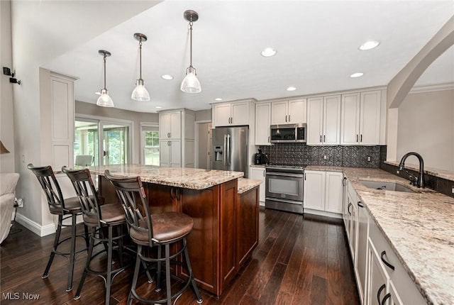 1152 Terraho Dr, Salem, OH 44460 - kitchen featuring appliances with stainless steel finishes, a sink, dark wood finished floors, light stone countertops, and recessed lighting