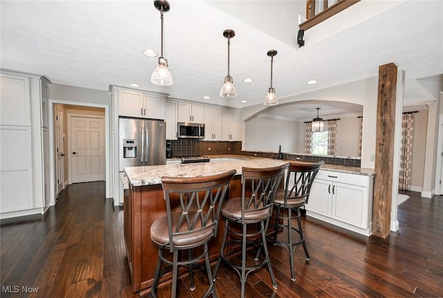 1152 Terraho Dr, Salem, OH 44460 - kitchen featuring stainless steel appliances, arched walkways, dark wood finished floors, tasteful backsplash, and recessed lighting