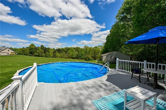 1152 Terraho Dr, Salem, OH 44460 - view of swimming pool with a wooden deck, a covered pool, a lawn, and an outbuilding