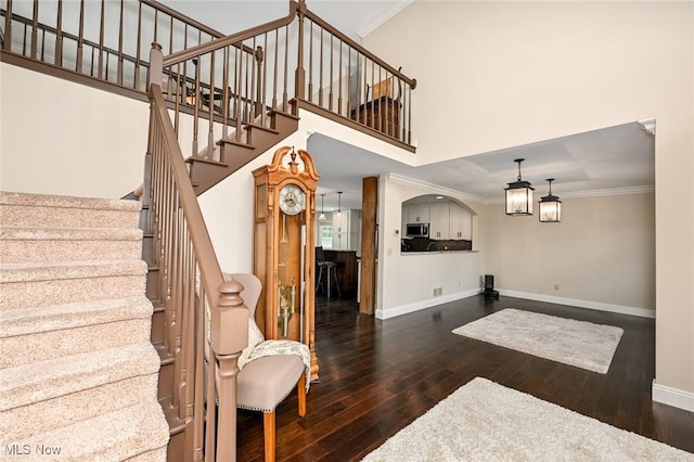1152 Terraho Dr, Salem, OH 44460 - entryway featuring wood-type flooring, baseboards, stairway, crown molding, and a high ceiling