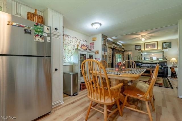 dining space featuring light wood-style floors and a ceiling fan
