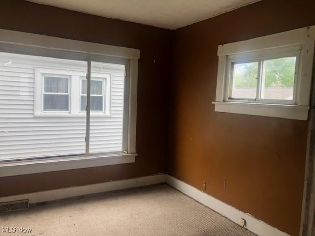 2117 Maple Ave NE, Canton, OH 44714 - unfurnished room with baseboards and light colored carpet