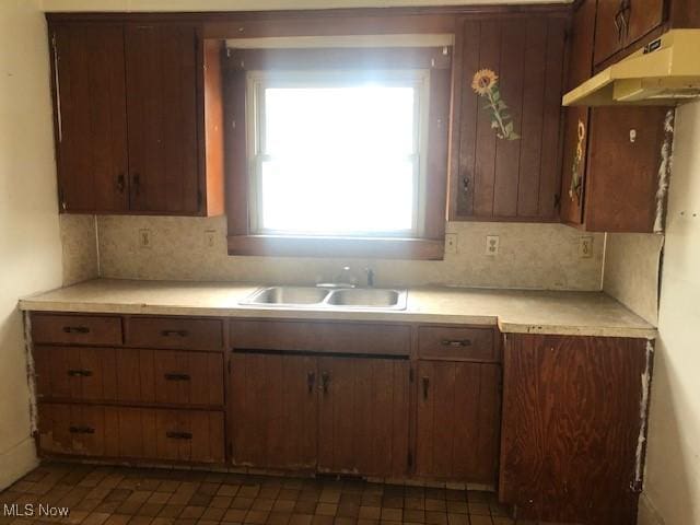2117 Maple Ave NE, Canton, OH 44714 - kitchen with a sink, light countertops, backsplash, and under cabinet range hood