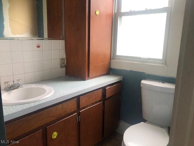 2117 Maple Ave NE, Canton, OH 44714 - half bathroom with vanity, backsplash, and toilet