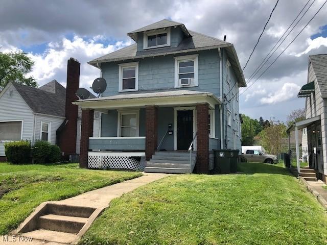 2117 Maple Ave NE, Canton, OH 44714 - american foursquare style home featuring covered porch and a front lawn