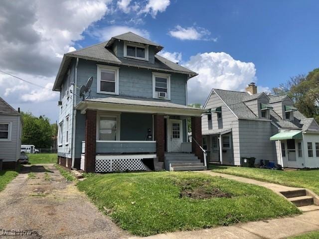 2117 Maple Ave NE, Canton, OH 44714 - american foursquare style home with covered porch and a front yard