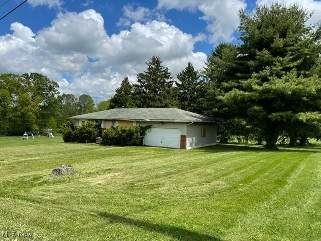 362 Jettie Ave NE, East Canton, OH 44730 - view of grassy yard featuring a garage
