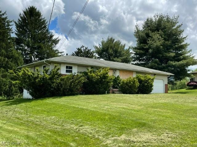362 Jettie Ave NE, East Canton, OH 44730 - view of home's exterior featuring an attached garage and a yard