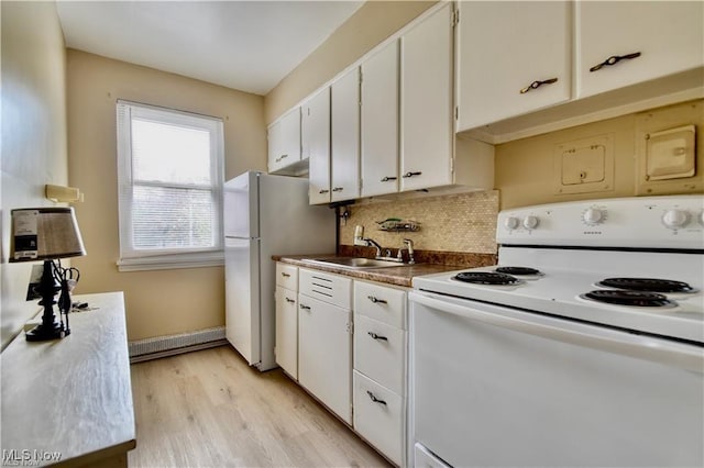 kitchen with white appliances, a sink, backsplash, light wood-type flooring, and white cabinetry