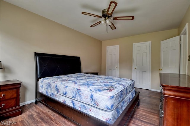 bedroom with dark wood-style floors, baseboards, and a ceiling fan