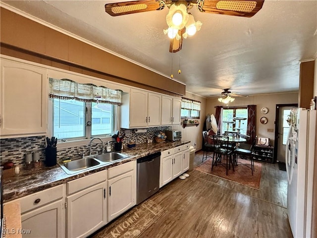 kitchen with a sink, dishwasher, a ceiling fan, white cabinetry, and freestanding refrigerator