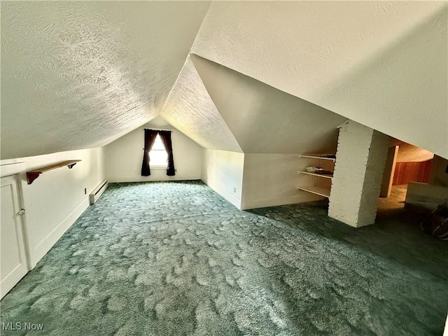 additional living space featuring a baseboard heating unit, carpet floors, a textured ceiling, lofted ceiling, and baseboards