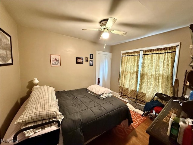 bedroom featuring wood finished floors and a ceiling fan