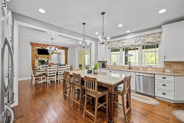 15020 Steelhead Run, Chardon, OH 44024 - dining room featuring a chandelier, dark wood-style floors, recessed lighting, and baseboards