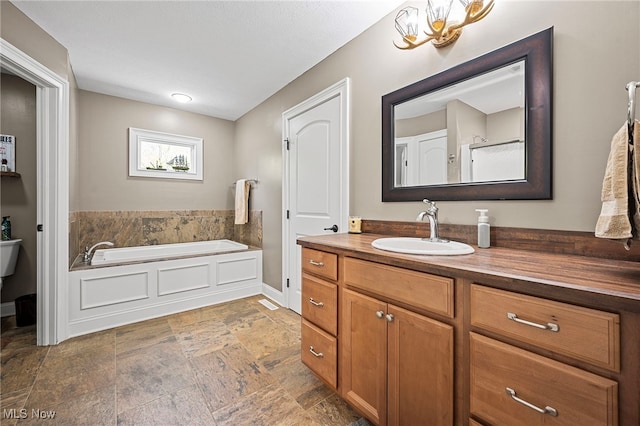 15020 Steelhead Run, Chardon, OH 44024 - full bathroom with stone finish flooring, a bath, vanity, and baseboards