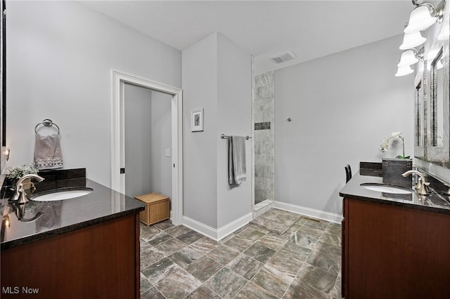 15020 Steelhead Run, Chardon, OH 44024 - full bathroom with two vanities, tiled shower, and baseboards
