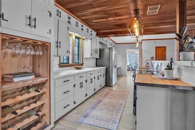555 E Milton St, Alliance, OH 44601 - kitchen featuring wood ceiling, freestanding refrigerator, ornamental molding, wood counters, and a sink