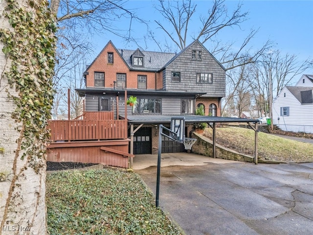 555 E Milton St, Alliance, OH 44601 - rear view of house with driveway, brick siding, and a carport