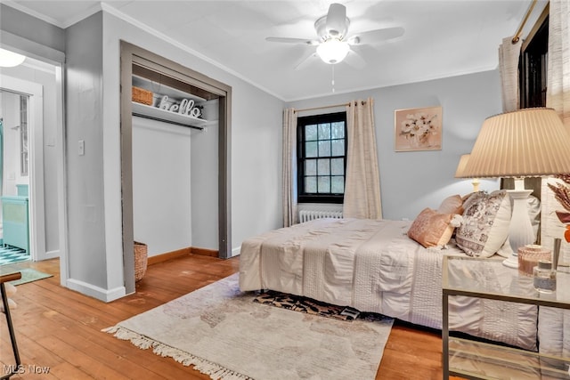 555 E Milton St, Alliance, OH 44601 - bedroom featuring hardwood / wood-style floors, a closet, crown molding, baseboards, and radiator heating unit