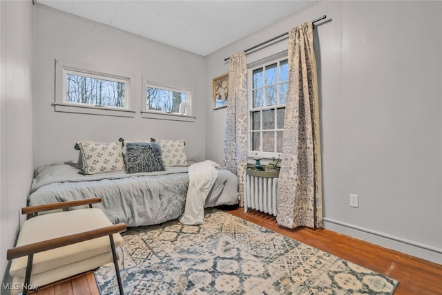555 E Milton St, Alliance, OH 44601 - bedroom with radiator, wood finished floors, and baseboards
