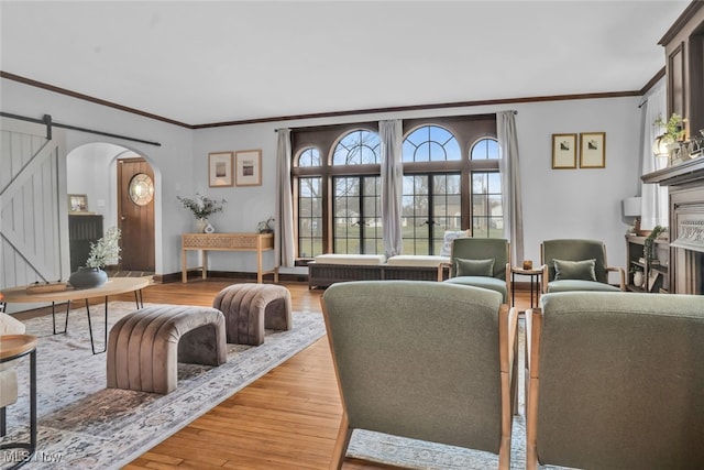555 E Milton St, Alliance, OH 44601 - living room with arched walkways, wood finished floors, crown molding, and baseboards