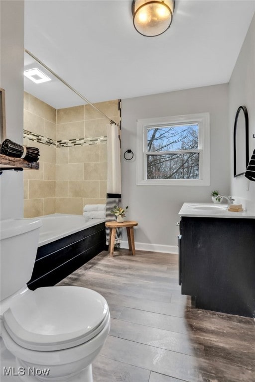 555 E Milton St, Alliance, OH 44601 - bathroom featuring toilet, shower / bath combo, wood finished floors, baseboards, and vanity