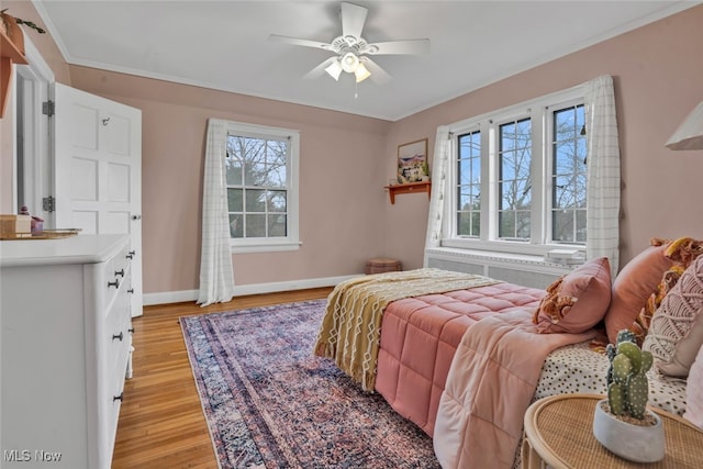 555 E Milton St, Alliance, OH 44601 - bedroom featuring light wood-style floors, radiator, baseboards, and a ceiling fan