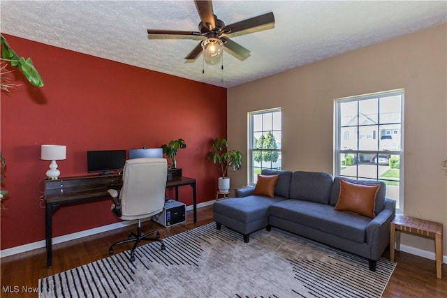 home office featuring baseboards, wood finished floors, a ceiling fan, and a textured ceiling