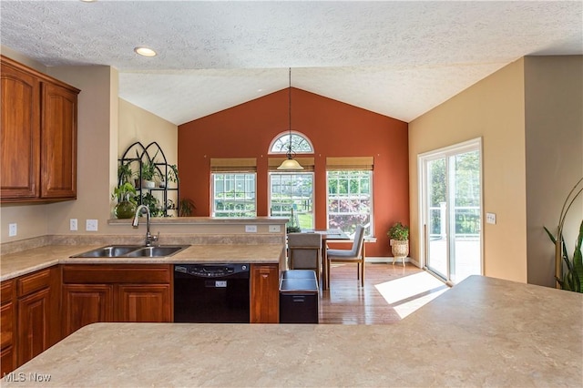 kitchen featuring dishwasher, a sink, brown cabinetry, wood finished floors, and lofted ceiling
