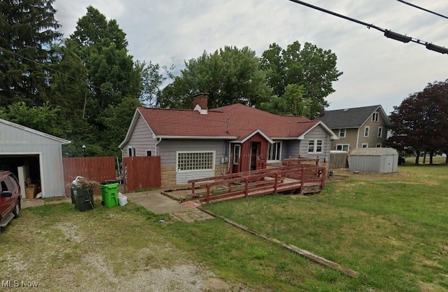 833 Rossland Rd, Alliance, OH 44601 - rear view of house with an outdoor structure, a storage shed, a chimney, and a garage