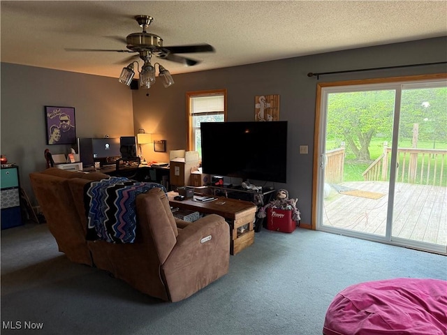carpeted living room with ceiling fan