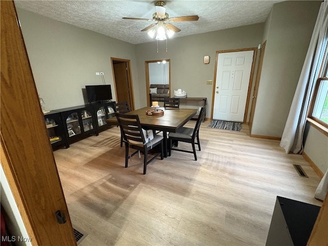 11153 Pleasant Rd, Pleasant City, OH 43772 - dining area with ceiling fan, light wood-style floors, a textured ceiling, and baseboards